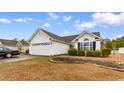 Charming single-story home with manicured lawn, two-car garage, and traditional design at 401 Barton Loop, Myrtle Beach, SC 29579