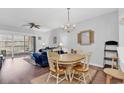 Cozy living room and dining area with hardwood floors, chandelier, and sliding door to balcony at 4449 Turtle Ln. # 3-C, Little River, SC 29566