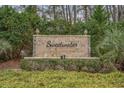 Stone sign for Sweetwater community with decorative shrubbery and trees in the background at 4502 Sweetwater Blvd. # 4502, Murrells Inlet, SC 29576