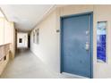 Hallway leading to condo with door and a decorative window at 4800 S Ocean Blvd. # 1514, North Myrtle Beach, SC 29582