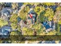 Overhead view of a home on a large, private lot surrounded by mature trees in a residential neighborhood at 52 Olde Canal Loop, Pawleys Island, SC 29585