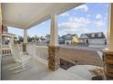 View from the covered porch with stone pillars and white rocking chairs at 521 Harbison Circle, Myrtle Beach, SC 29579