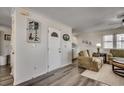 Inviting entryway featuring hardwood floors, a charming lighthouse print, and a glimpse into the living space at 547 South Waccamaw Dr., Garden City Beach, SC 29576