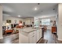 Open-concept kitchen with granite countertops, stainless steel appliances, and wood floors at 583 Meadowgrass Ct., Myrtle Beach, SC 29588