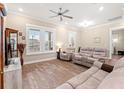 Bright living room with hardwood floors, ceiling fan, and comfortable seating arrangement at 8155 Living Tide Dr., Myrtle Beach, SC 29572