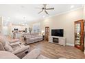 Open-concept living room showcasing hardwood floors, neutral decor, and modern ceiling fan at 8155 Living Tide Dr., Myrtle Beach, SC 29572