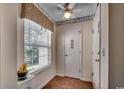 Bright hallway with wood floors, decorative wallpaper, and a window letting in natural light at 8545 Hopkins Circle # G, Myrtle Beach, SC 29575