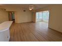 Spacious living room with laminate flooring, bay window, and a ceiling fan at 8545 Hopkins Circle # G, Myrtle Beach, SC 29575