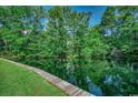Scenic view of a pond surrounded by lush greenery and trees with a wooden boardwalk at 8545 Hopkins Circle # G, Myrtle Beach, SC 29575