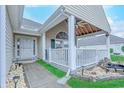 Inviting front porch featuring white railings, stylish decor, and a decorative water feature at 920 Leather Leaf Ln., Longs, SC 29568