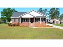 Beautiful brick home with a well-manicured lawn, front porch, and tasteful landscaping at 960 South Farr Ave., Andrews, SC 29510