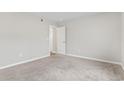 A simple and clean bedroom features neutral walls, carpet floors and a door to another room at 125 South Shore Blvd. # 201, Longs, SC 29568