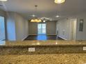 View of the living room from the breakfast bar, showcasing the hardwood floors and balcony at 125 South Shore Blvd. # 201, Longs, SC 29568