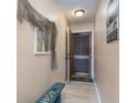 Inviting hallway with beach decor, tiled flooring, and a view of the front door at 1305 S Ocean Blvd. # 204, North Myrtle Beach, SC 29582