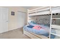 bedroom featuring carpet flooring, white walls, closet, and bunk bed at 1529 Lanterns Rest Dr. # 201, Myrtle Beach, SC 29579