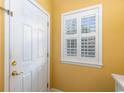 Bright entryway with yellow walls, white door, and window with plantation shutters at 1529 Lanterns Rest Dr. # 201, Myrtle Beach, SC 29579