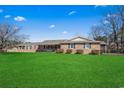 Charming single-story brick home featuring a well-manicured lawn and inviting curb appeal at 1586 Bridgebrook Ln., Conway, SC 29527