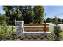 Landscaped entrance sign for Hoffman Park, framed by trees and bushes at 159 Hoffman Park Dr. # 79, Myrtle Beach, SC 29588