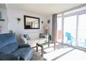 Bright living room featuring coastal decor, a comfortable sofa, and sliding glass doors to the balcony at 1604 N Ocean Blvd. # 605, Myrtle Beach, SC 29577