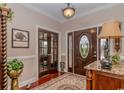 Inviting foyer with a decorative front door, hardwood floors, and elegant decor welcomes you into this home at 1796 Fairwinds Dr., Longs, SC 29568