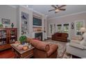 Comfortable living room with a fireplace, built-in shelves, and comfortable seating provides the perfect space to relax at 1796 Fairwinds Dr., Longs, SC 29568