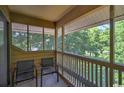 Screened balcony provides comfortable seating and a view of the lush landscape at 180 Rothbury Circle # 303, Myrtle Beach, SC 29572