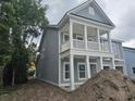 Stylish two-story home featuring a welcoming porch with white columns at 1808 Sunshine Ct., North Myrtle Beach, SC 29582