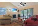 Bright living room featuring a fireplace, ceiling fan, and sliding glass doors to the balcony at 222 Westleton Dr. # 18D, Myrtle Beach, SC 29572