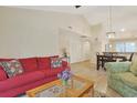 Inviting living room adjacent to the dining area, with a red sofa and cozy seating at 222 Westleton Dr. # 18D, Myrtle Beach, SC 29572