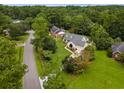 Overhead view of a wooded community with a home, driveway, and well-maintained landscaping at 2264 Wedgefield Rd., Georgetown, SC 29440