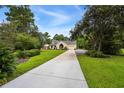 Traditional home with attached garage and a long driveway surrounded by mature landscaping at 2264 Wedgefield Rd., Georgetown, SC 29440