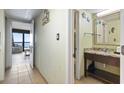 Bathroom with a modern vanity, granite countertop, and a doorway to the balcony at 2311 S Ocean Blvd. # 969, Myrtle Beach, SC 29577