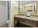 Nicely decorated bathroom featuring granite countertops, a sink, and a large mirror at 2311 S Ocean Blvd. # 969, Myrtle Beach, SC 29577