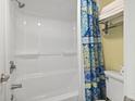 Close-up of a clean, modern shower with blue patterned shower curtain, white tiles, and fresh towels at 2311 S Ocean Blvd. # 969, Myrtle Beach, SC 29577