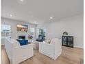 Cozy living room with fireplace, hardwood floors, neutral walls, and a sliding glass door at 2341 Hazel Way, Longs, SC 29568