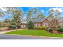 Beautifully landscaped front yard with healthy green grass leading up to a well-maintained brick home at 25 Berwick Dr., Pawleys Island, SC 29585