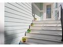 Charming staircase leading to the front door, adorned with colorful potted plants at 301 Lumbee Circle, Pawleys Island, SC 29585