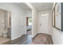 Inviting entryway featuring wood flooring, white walls and trim, leading to bedroom and bathroom at 365 Rookroost Circle, Conway, SC 29526