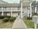 Charming condo entrance featuring a white door, and well-maintained landscaping at 3677 Claypond Village Ln. # 4, Myrtle Beach, SC 29572