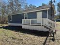 Side view of home with white railing and a door leading outside at 415 Circle Dr., Johnsonville, SC 29555