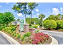 Scenic Windsor Green entrance featuring lush landscaping and community signage at 4935 Crab Pond Ct. # 203, Myrtle Beach, SC 29579