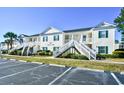 Attractive condo featuring classic white siding, green shutters and outside access at 4935 Crab Pond Ct. # 203, Myrtle Beach, SC 29579