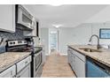 Modern kitchen with stainless steel appliances, granite countertops, and a view to the bathroom at 5905 South Kings Hwy. # 5308, Myrtle Beach, SC 29575