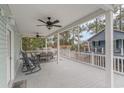 Expansive porch has ceiling fans, furniture and overlooks neighboring homes and lush trees at 6001-1723 South Kings Hwy., Myrtle Beach, SC 29575