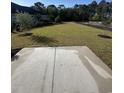 Expansive backyard featuring a concrete patio, well-maintained lawn, and newly planted trees at 641 Waterbridge Blvd., Myrtle Beach, SC 29579