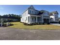 Beautiful two-story home with manicured lawn, featuring light gray siding and white trim at 641 Waterbridge Blvd., Myrtle Beach, SC 29579