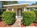 Close-up of the front entrance, showcasing a welcoming doorway and neatly trimmed landscaping at 6512 Laguna Point, Myrtle Beach, SC 29588