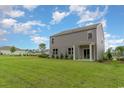 Exterior of home featuring a spacious yard and covered porch at 692 Wallace Dr., Little River, SC 29566