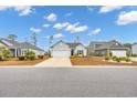 A well-maintained home with a two-car garage and professionally landscaped front yard at 820 Wild Leaf Loop, Conway, SC 29526