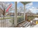 View from the porch, showcasing a cozy seating area with a patterned rug and neighborhood street at 823 Howard Ave., Myrtle Beach, SC 29577